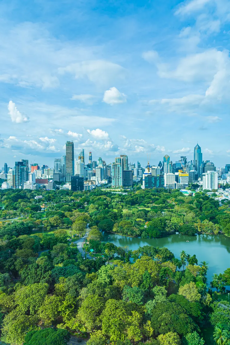 Bangkok around Lumphini Park, with towers, trees, and the lake at the heart of the city