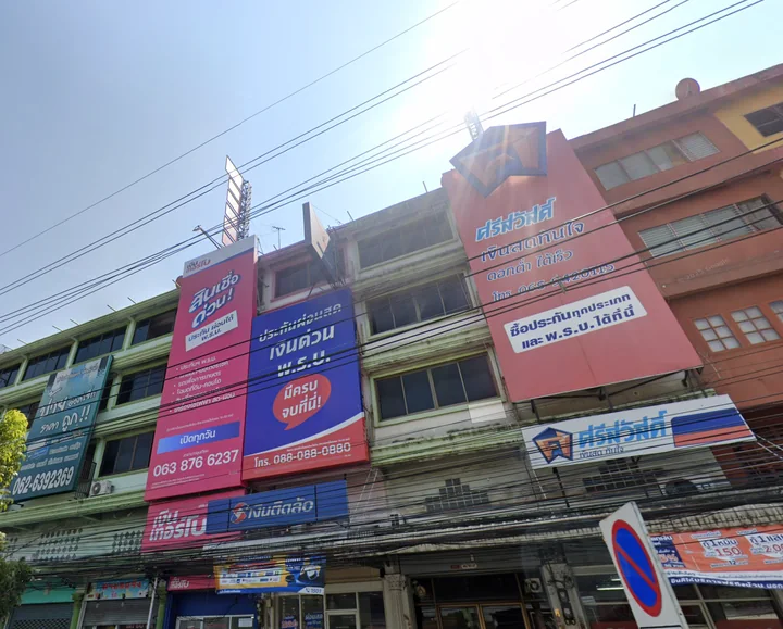 Several commercial buildings and business signs within the same area