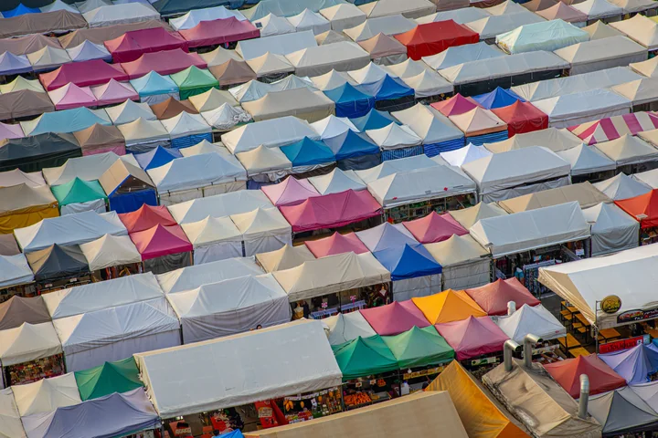Colourful market tents extending across a large trading area
